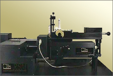 Large black spectrophotometer system with multiple connected components and adjustment knobs on a laboratory bench