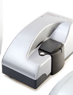 analytical ultracentrifuge with control panel and open rotor chamber in a laboratory corner