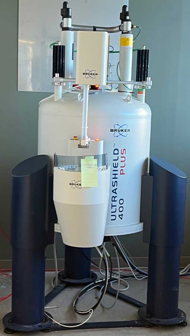 Bruker UltraShield 400 Plus nuclear magnetic resonance spectrometer standing in a lab with cables and support structures