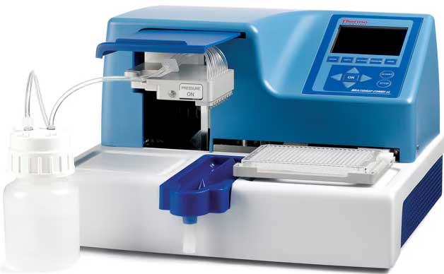 A Thermo Scientific blue and white microplate washer machine with a control panel and attached tubing connected to a plastic bottle