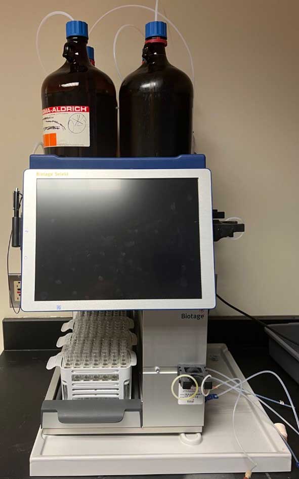 Biotage Selekt automated chromatography system with two solvent bottles on top and a touchscreen interface in a laboratory setting