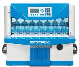Sotax dissolution testing system with multiple clear vessels and a blue-and-white housing used for pharmaceutical tablet testing