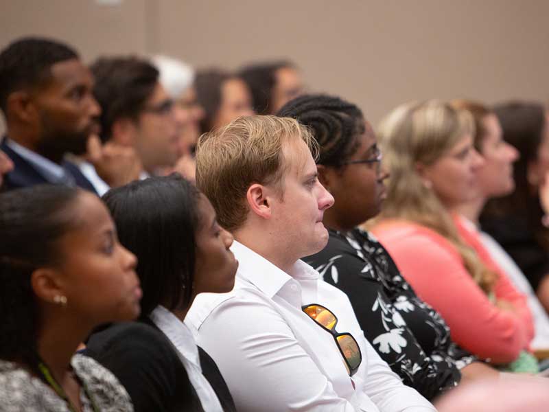Audience members seated and listening attentively during a School of Pharmacy event